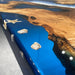 Close-up of a blue resin-embedded wooden surface with seashells.