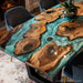Green swirl resin flowing through live edge burl wood tabletop