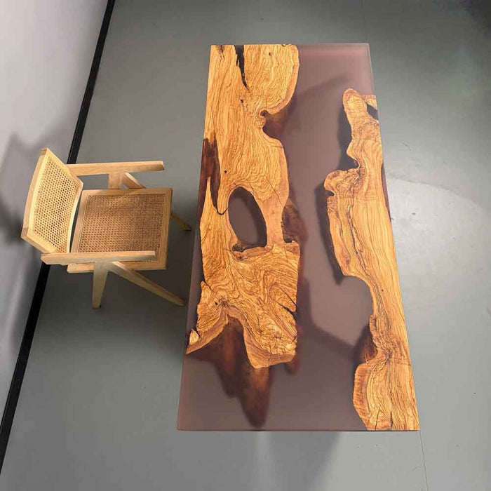 Wooden table with a wicker chair on a gray background