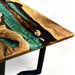 Wooden table with green and gold resin inlay on a white background