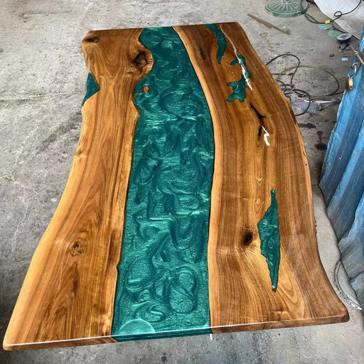 Handcrafted black walnut epoxy table with live edge and peacock green resin details