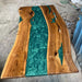 Handcrafted black walnut epoxy table with live edge and peacock green resin details