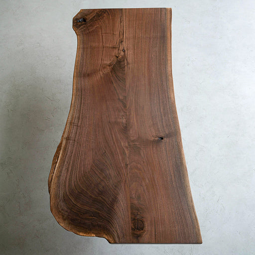 Handcrafted black walnut table with irregular shape and organic wood texture
