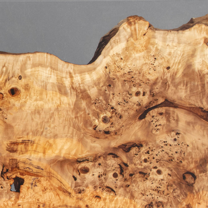 Handcrafted camphor wood and resin table in luxury interior