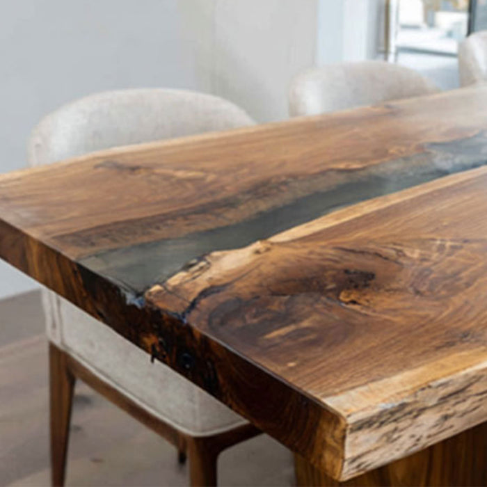 Handcrafted epoxy dining table with live edge walnut slabs and resin.