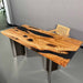 Wooden desk with black resin inlay on a gray floor