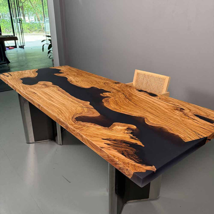 Wooden desk with black resin inlay on a gray floor