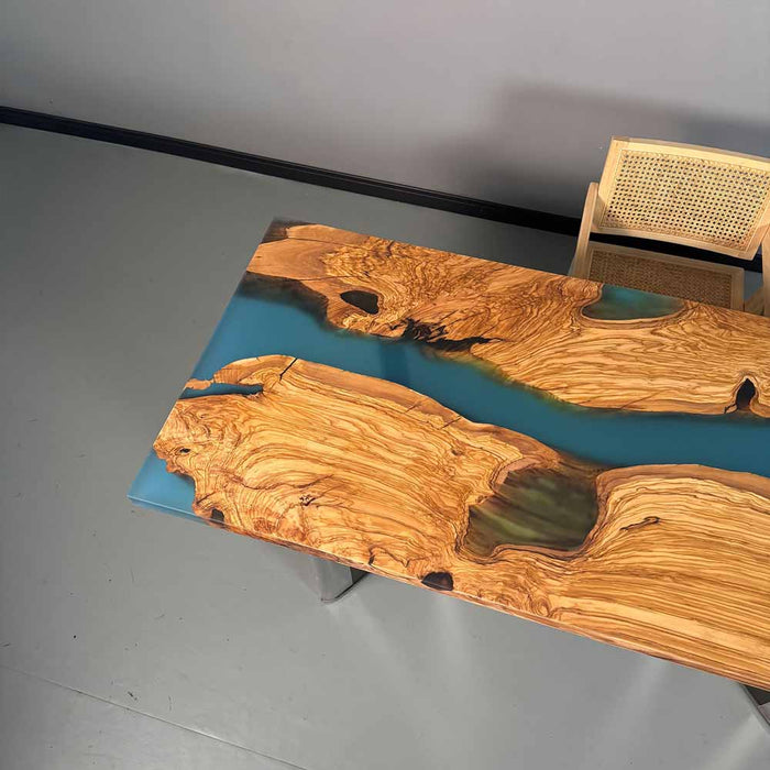 Wooden table with blue resin inlay on a gray floor