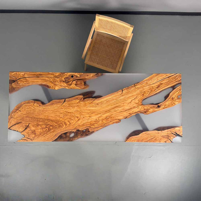 Wooden table with natural edge design on a gray surface