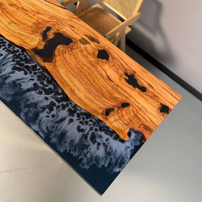 Wooden table with black resin inlay on a dark blue epoxy resin surface