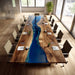 Modern conference room with a unique wooden table featuring a blue resin river.
