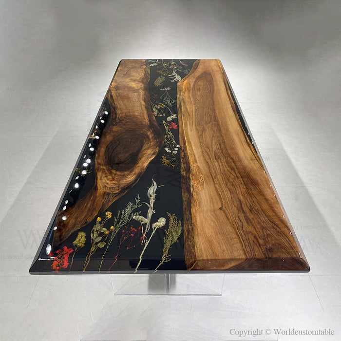 Handcrafted walnut table with black epoxy resin and floral inlay, modern luxury dining table design