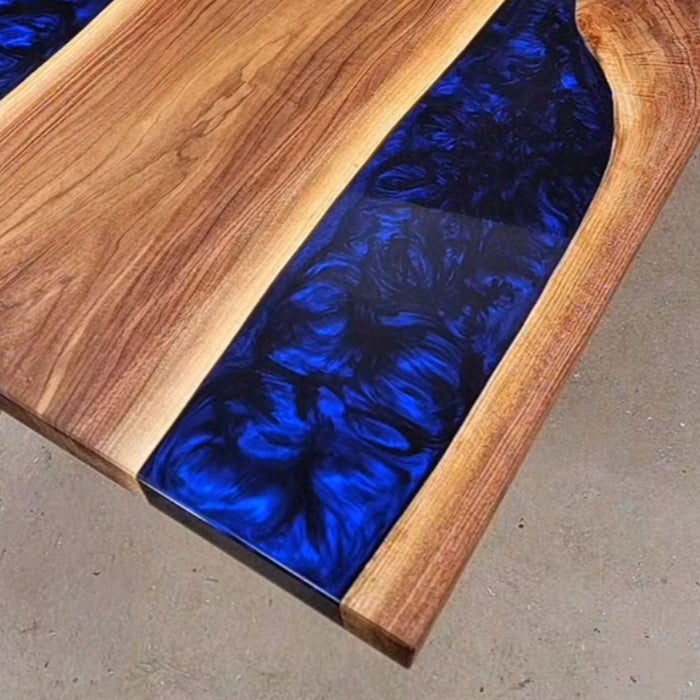 Handcrafted walnut wood and blue resin dining table for high-end interiors