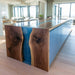 Handcrafted walnut table with blue resin river in living room