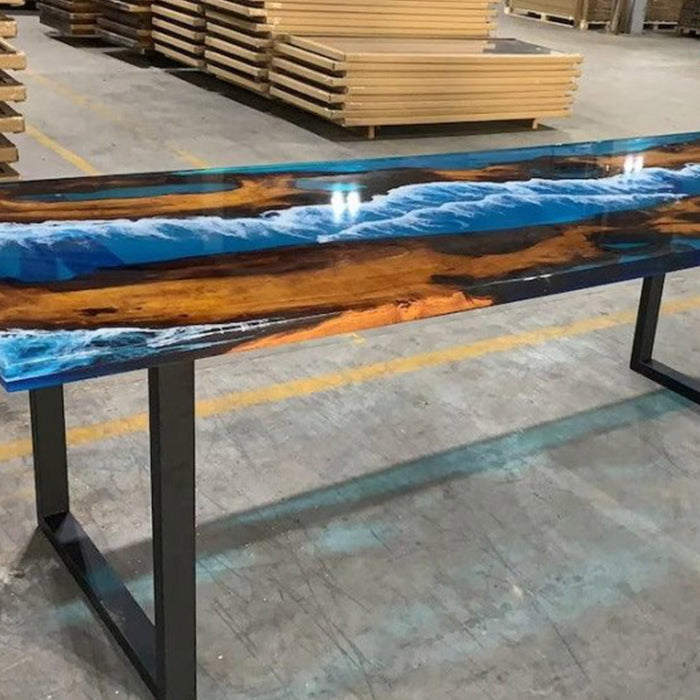 Wooden table with blue resin finish in a warehouse setting
