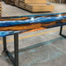 Wooden table with blue resin finish in a warehouse setting