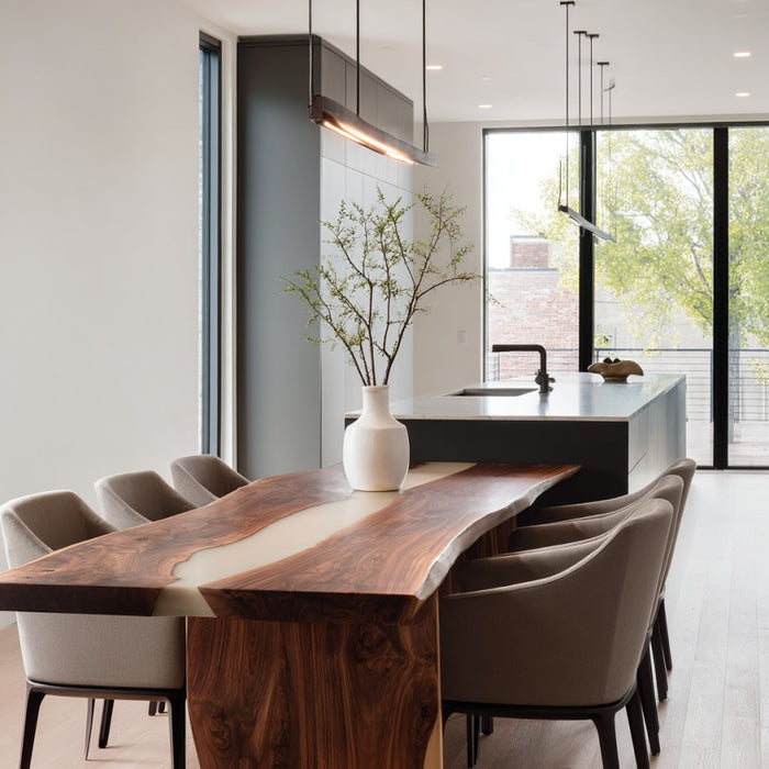 Modern kitchen with wooden dining table and chairs, featuring a vase with branches on the table.