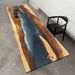 Wooden table with blue resin inlay in a modern interior setting