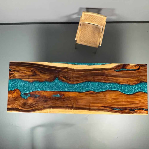 Wooden table with blue resin inlay on a gray background