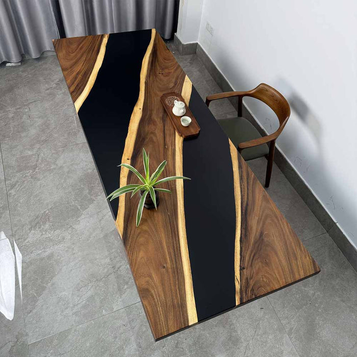 Wooden table with black resin inlay in a room setting