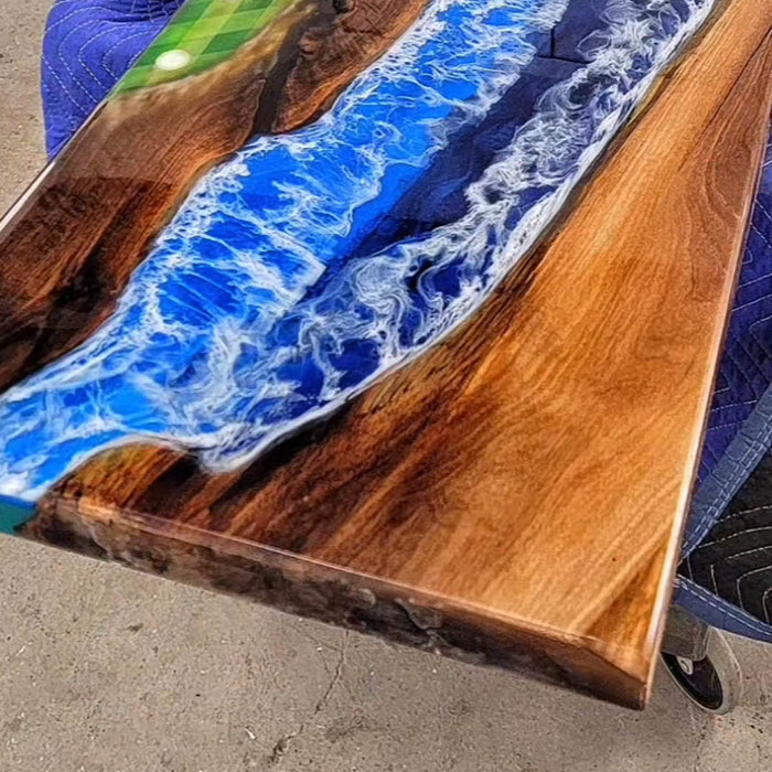 Handcrafted live edge walnut table with deep blue epoxy ocean effect