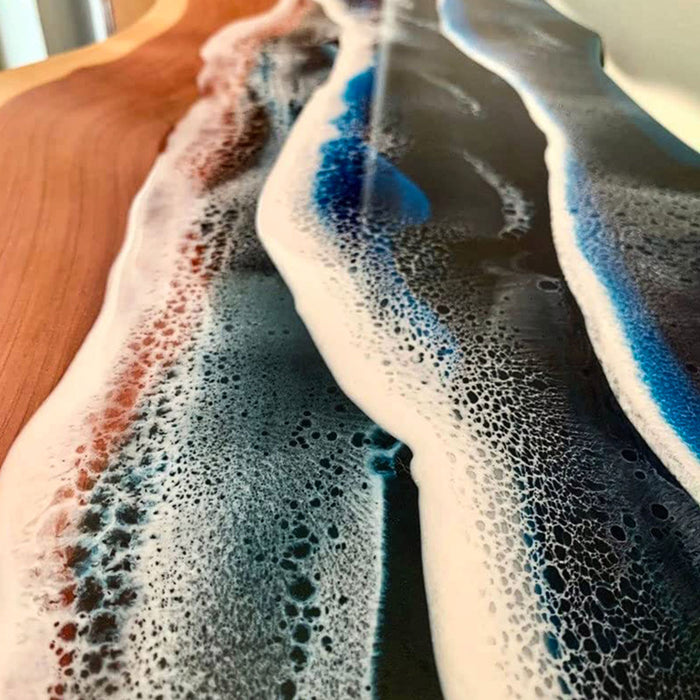 Foamy liquid being poured onto a surface with a wooden background