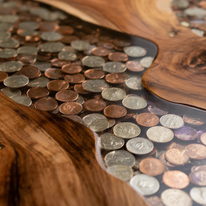 Tabletop made of interlocking coins with a wooden edge