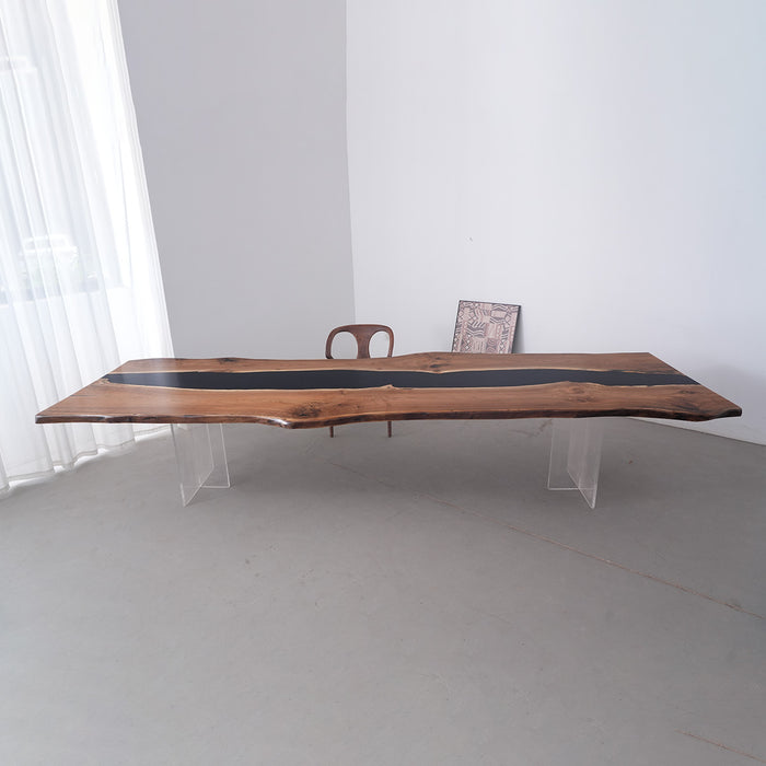 Wooden dining table with black resin inlay in a minimalistic room.