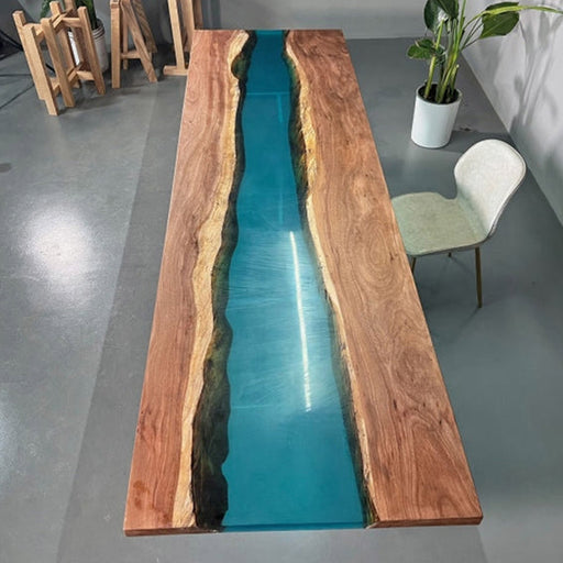 Handcrafted wood and resin table with a sleek modern river design, combining natural wood grain with a vivid turquoise epoxy river effect.