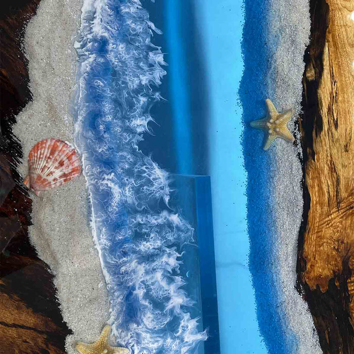 Artistic depiction of a beach scene with blue water, sand, and sea creatures.
