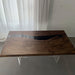 Black epoxy river dining table in a modern kitchen with mountain view.