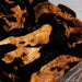 Close up of burl wood grain and black resin epoxy waterfall table