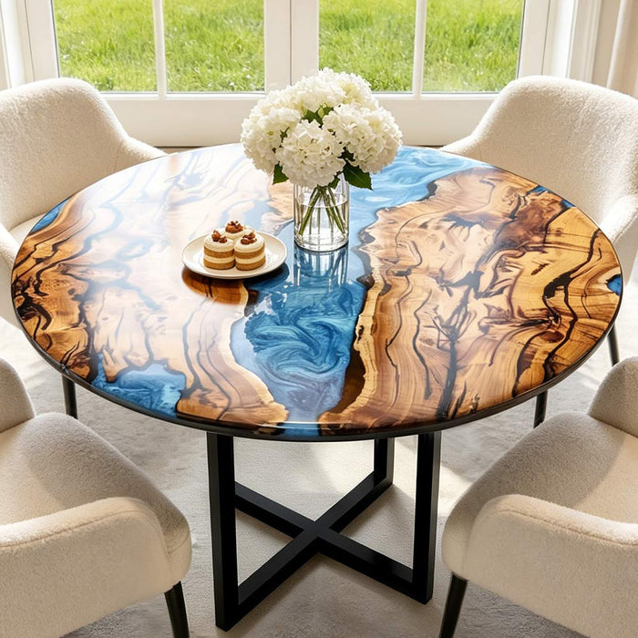 Close-up of the blue epoxy resin river pattern on a round olive wood coffee table
