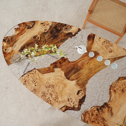 Custom clear resin coffee table mimicking frozen ice and natural wood.