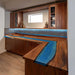 Handmade L-shaped kitchen countertop showcasing walnut grain and mysterious blue epoxy