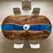 Top view of a handcrafted oval table showcasing the rich wood grain of American black walnut and blue resin art.