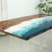 Wooden table with a blue resin river design on a white background