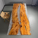 Close-up of natural olive wood grain sealed under transparent crystal resin tabletop.