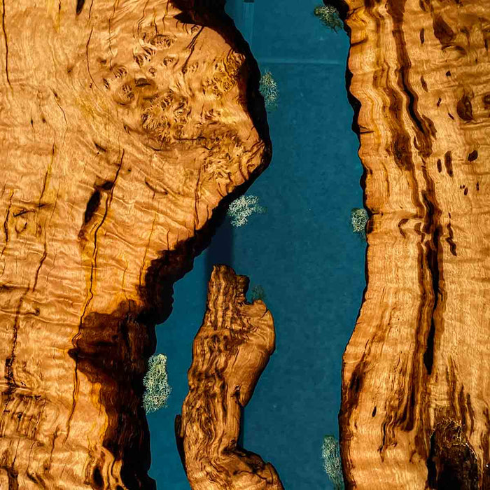 Aerial view of a river flowing between two rocky cliffs with blue water.