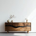 Wooden sideboard with decorative items against a white wall