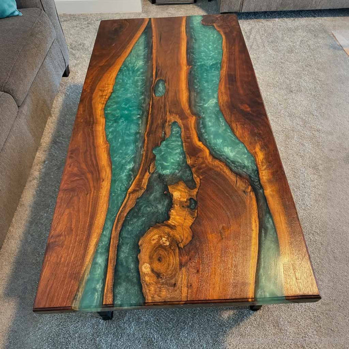 Handcrafted walnut wood table with natural grain and flowing epoxy river.