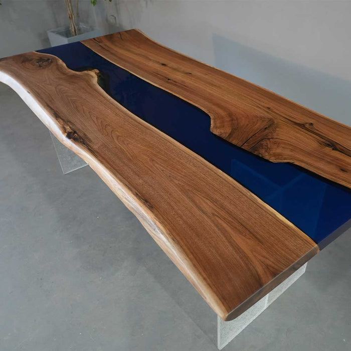 Handcrafted walnut wood table featuring a smooth blue epoxy river center.