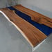 Handcrafted walnut wood table featuring a smooth blue epoxy river center.