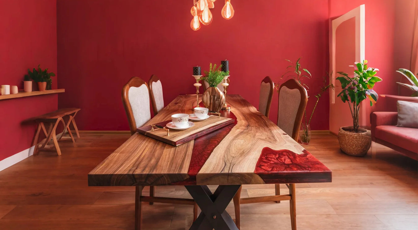 Dining room with wooden table, chairs, and red walls.