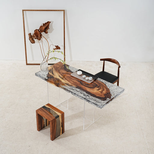 Handmade clear-tinted ice crystal epoxy river table with natural wood slab legs, modern resin furniture.