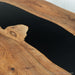 Wooden table with a black resin inlay