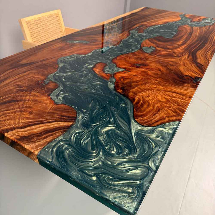 Wooden table with a unique design of swirling patterns in brown, green, and red.
