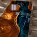 Custom walnut resin dining table with a deep blue epoxy center, showcasing unique grain patterns and refined craftsmanship.
