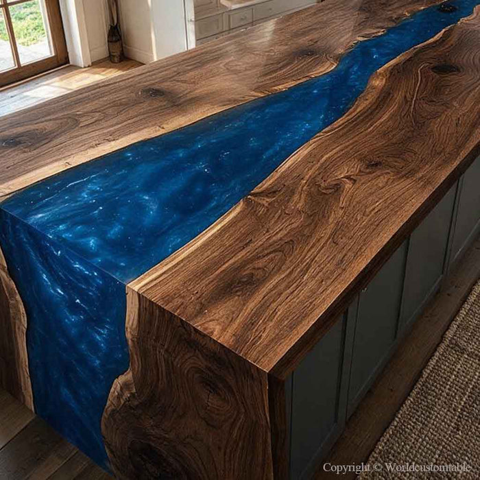 A live-edge wooden kitchen island with a glossy deep blue resin river running through the center, shown in a real indoor kitchen environment.