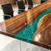 Custom walnut epoxy resin dining table designed with a unique green resin center and handcrafted details for contemporary interiors.